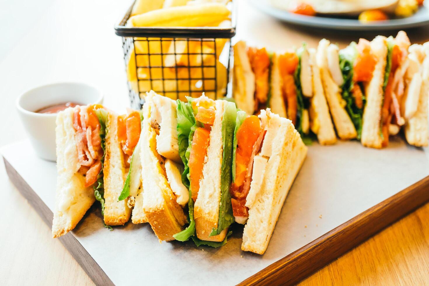 A tray with sandwiches and fries on it photo