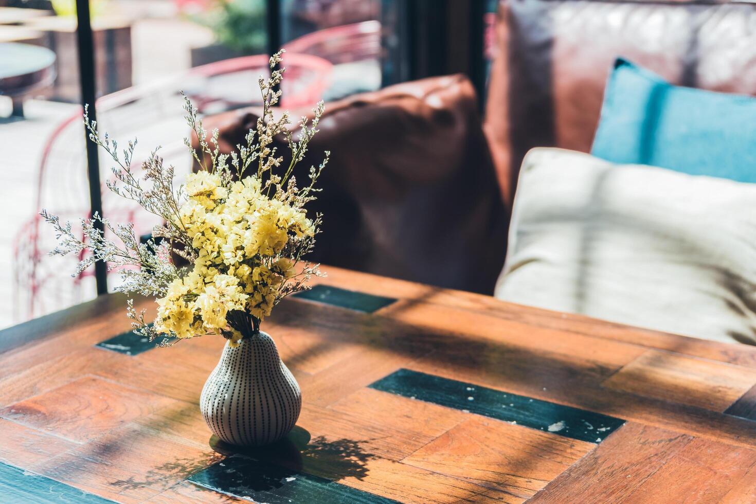 A vase with flowers sitting on a table photo