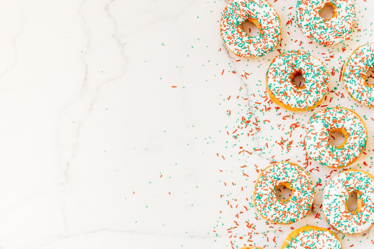 A white marble surface with a bunch of colorful sprinkles photo