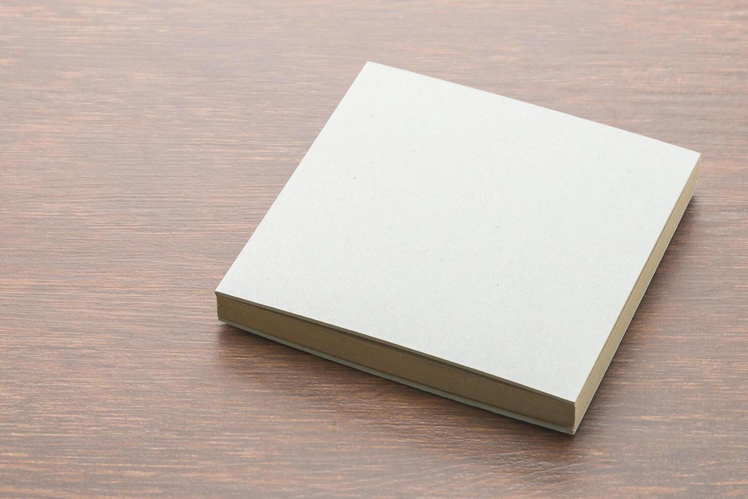 Blank white paper book on wooden table photo