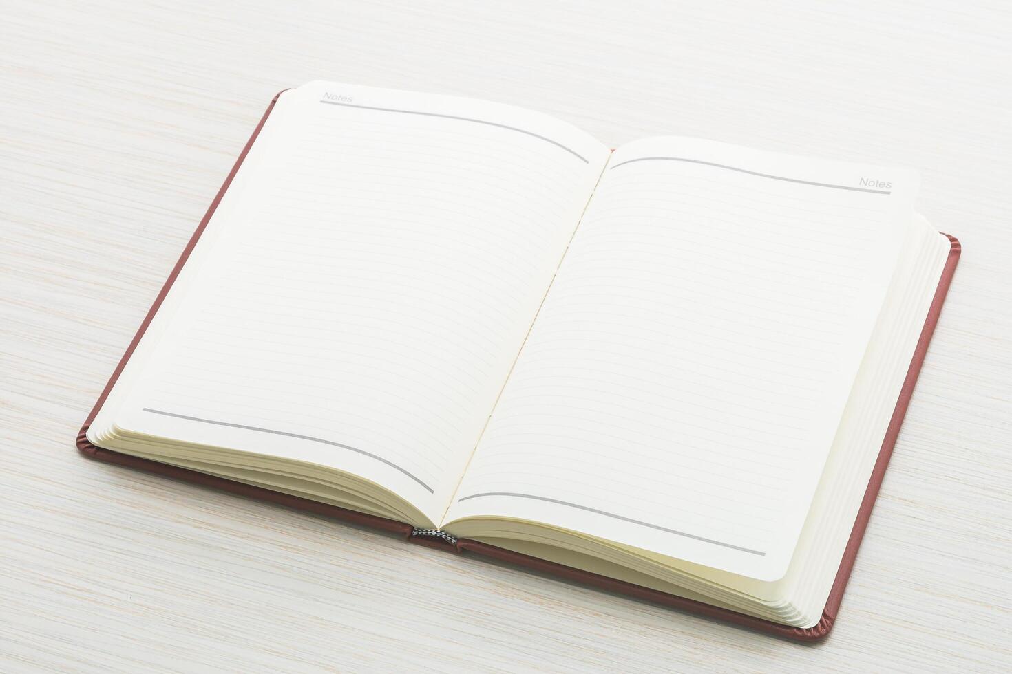 Open notebook on white table with copy space photo