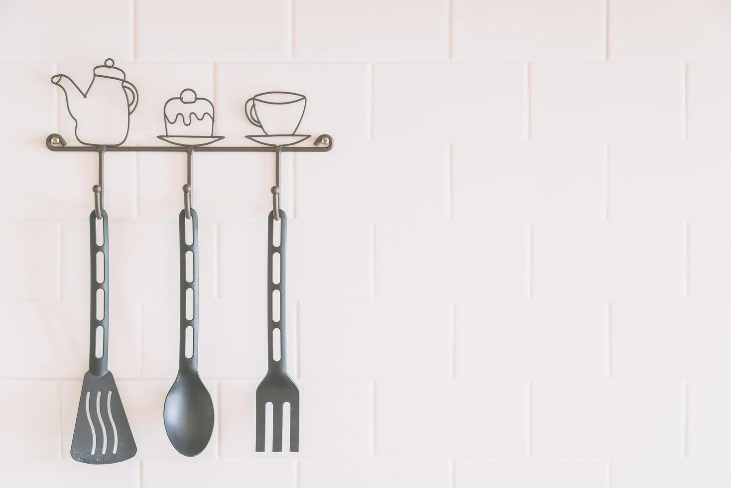 Kitchen utensils hanging on a wall photo