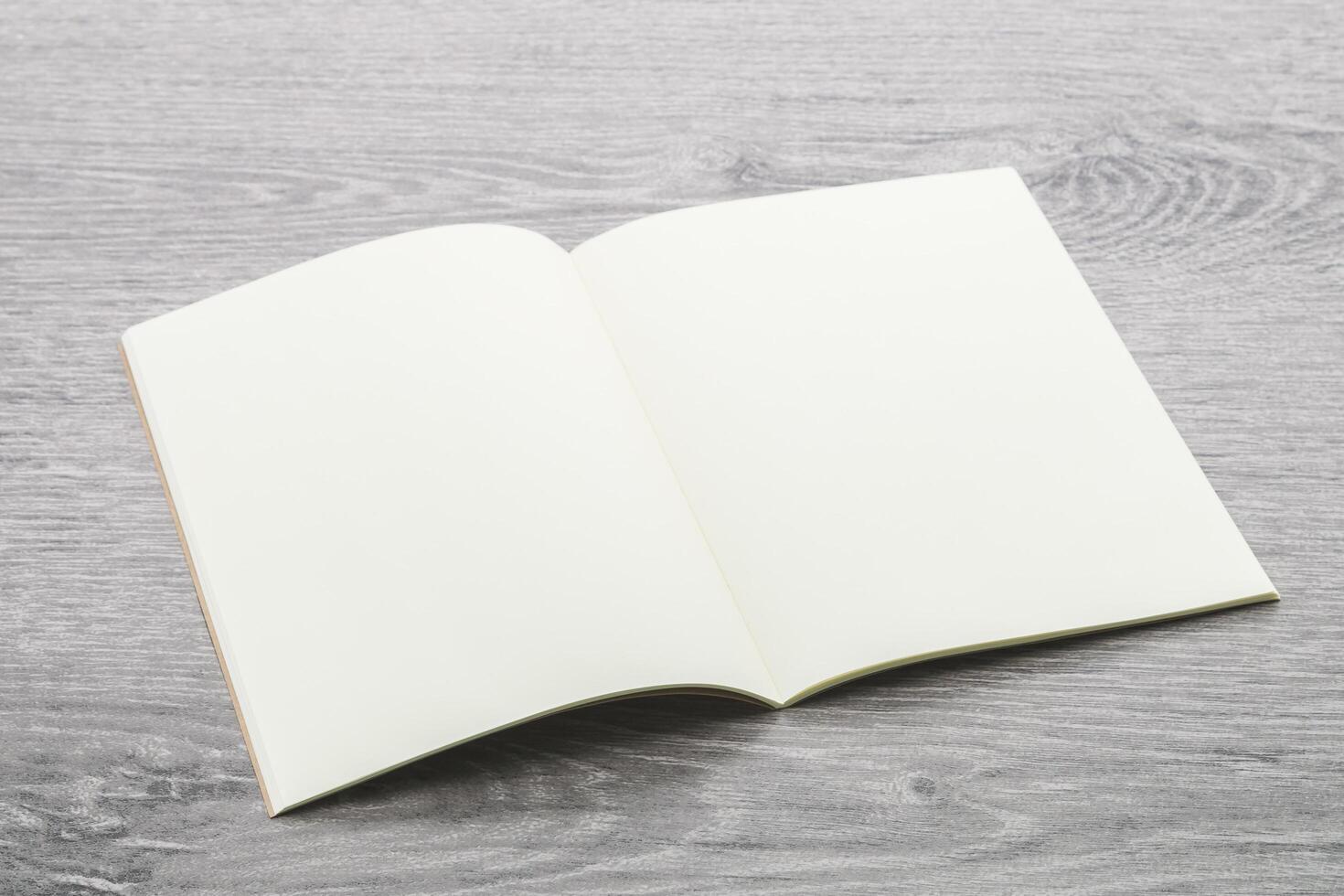 Open blank notebook on wooden table photo