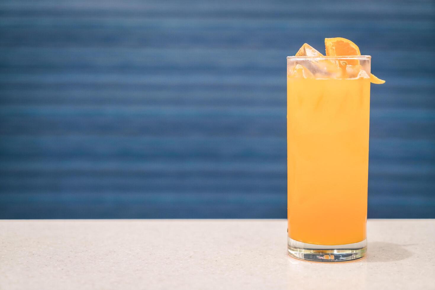 Orange and lime cocktail with a splash of soda photo