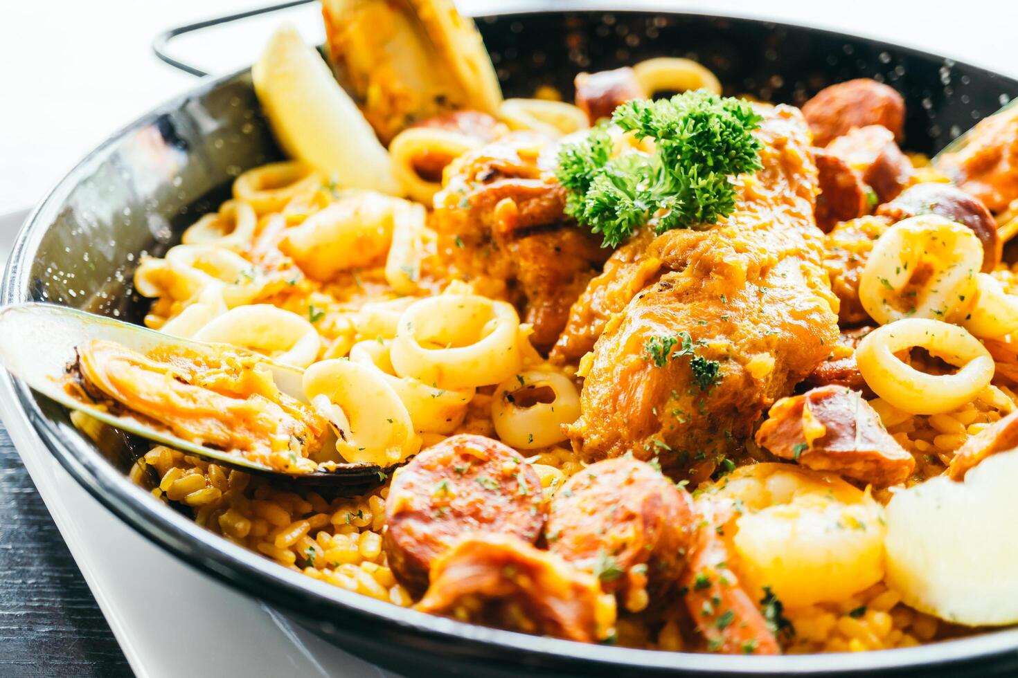 A pan with food in it and a spoon photo