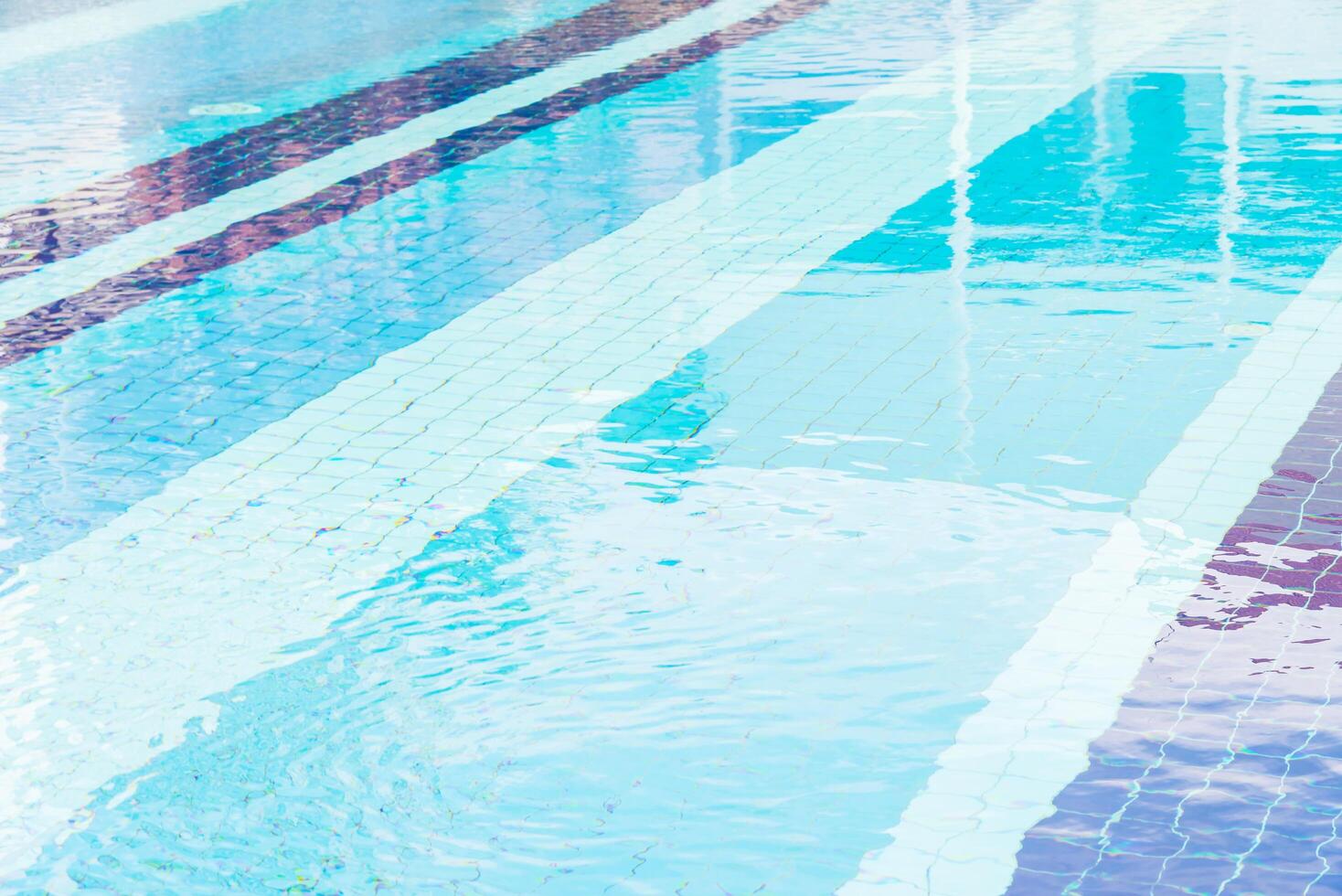 A person is standing in the middle of a swimming pool photo
