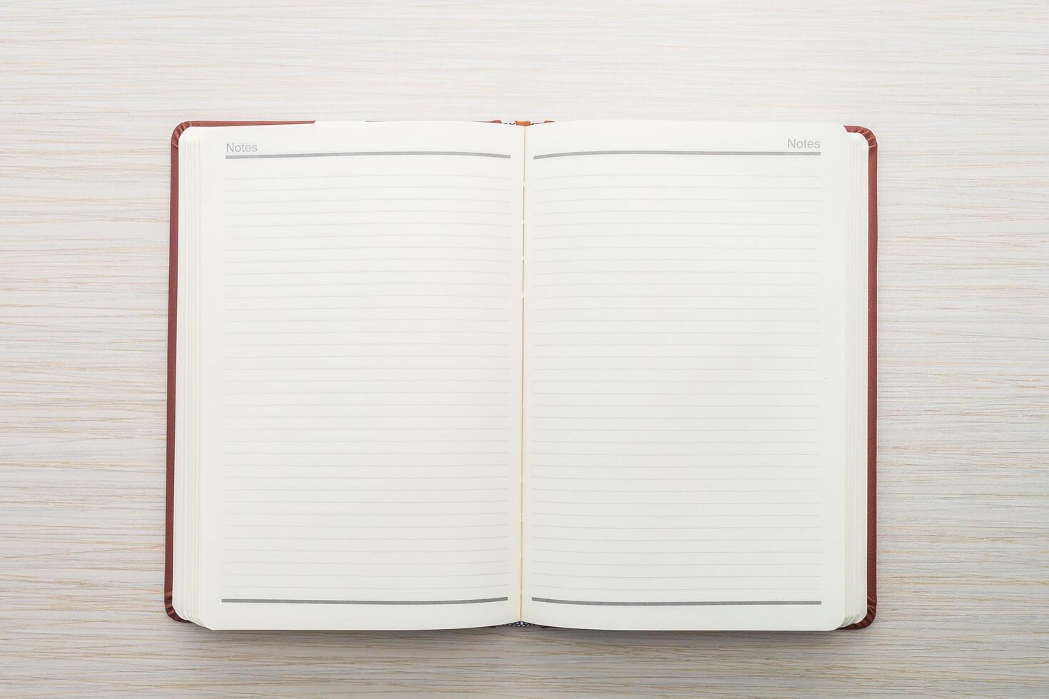 An open notebook with blank pages on a wooden surface photo