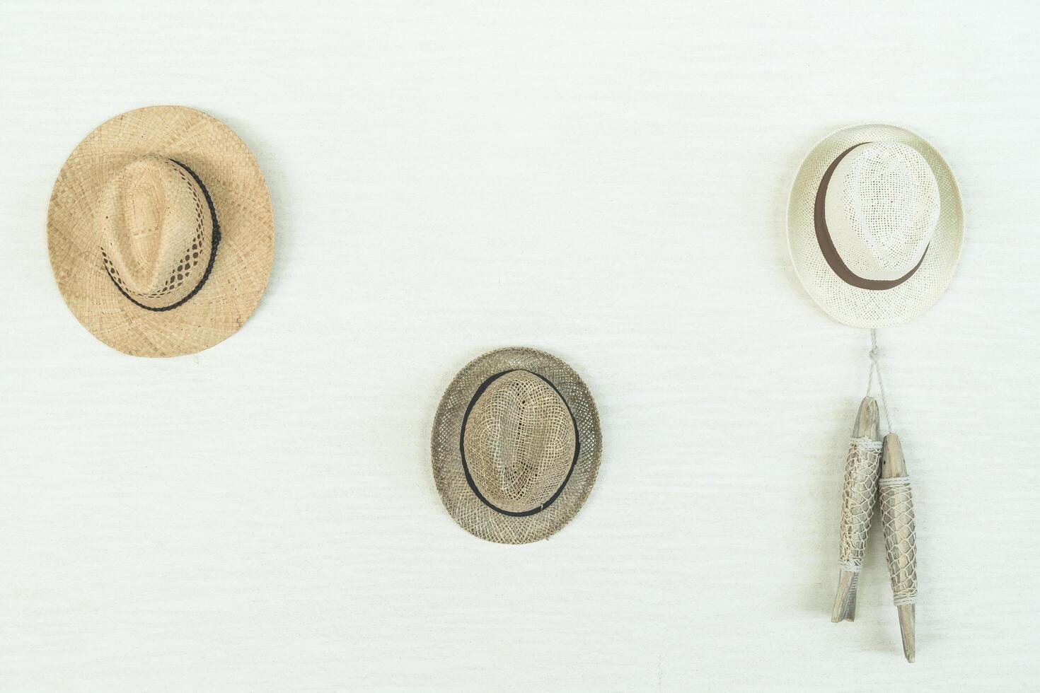 Three hats hanging on a wall photo