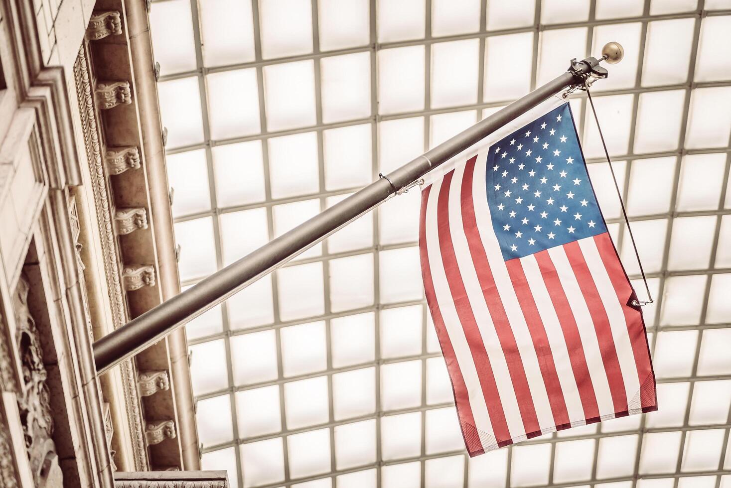 An american flag is hanging from a building photo