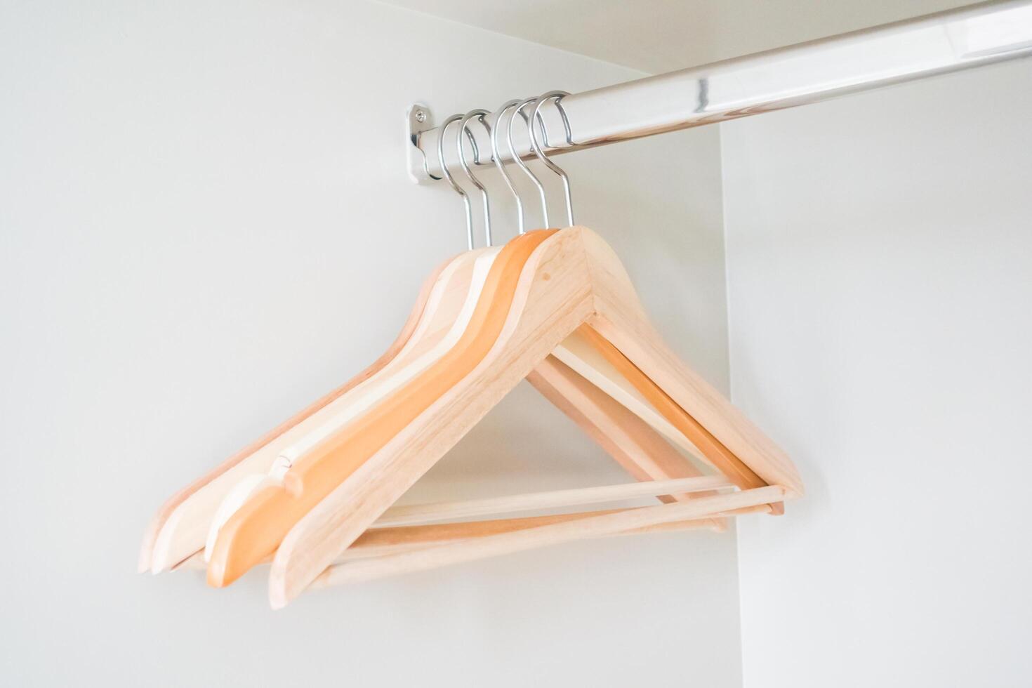 A wooden hanger hangs on a wall photo