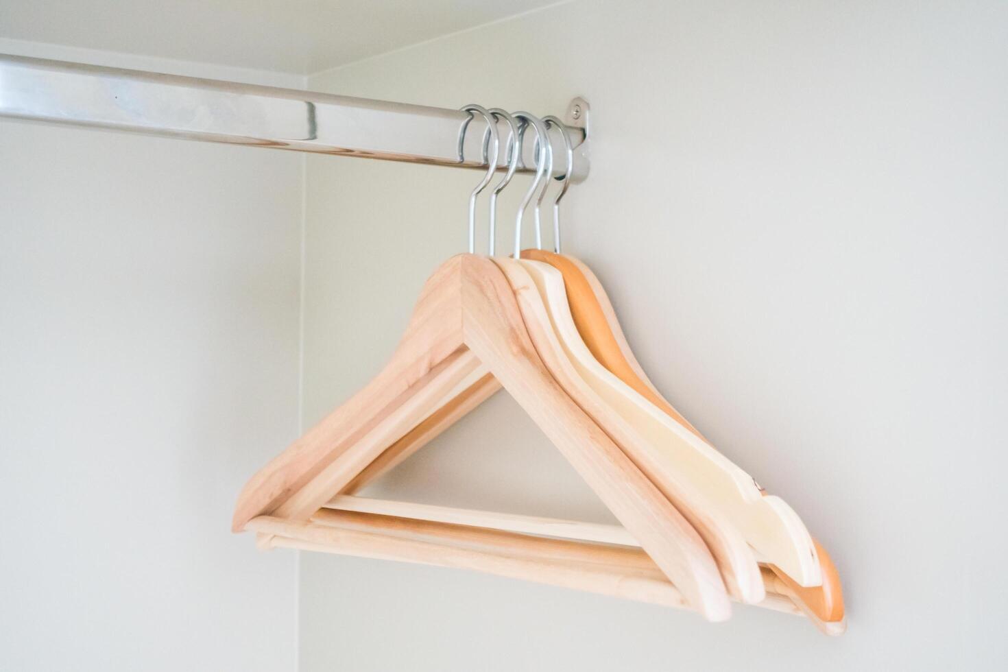 A wooden hanger hangs on a wall photo