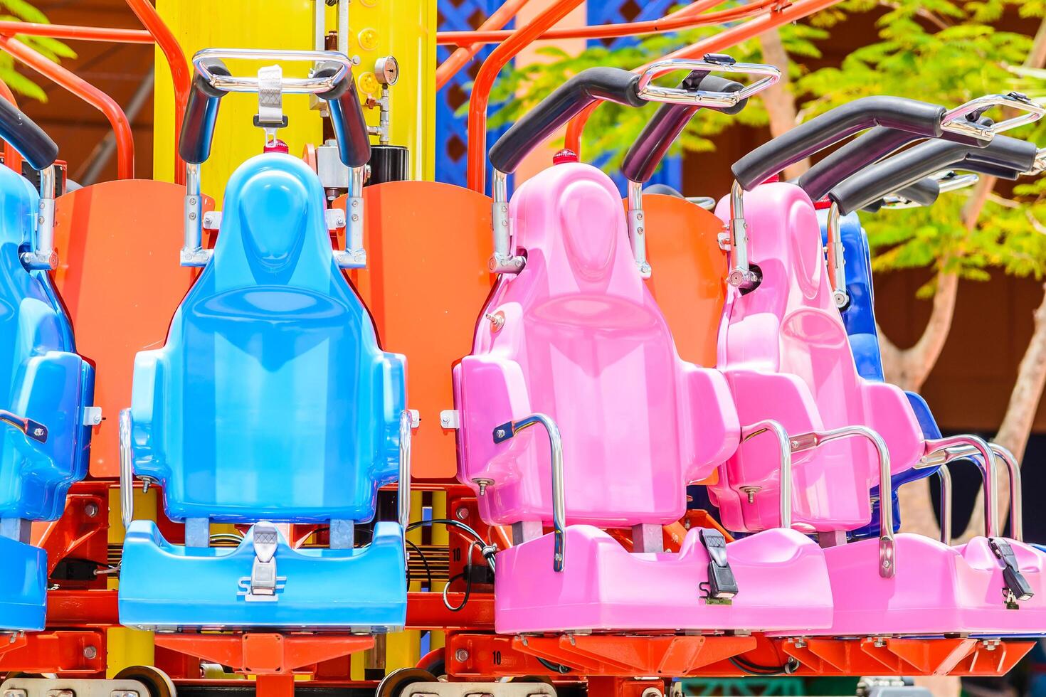 A row of colorful seats on a carnival ride photo