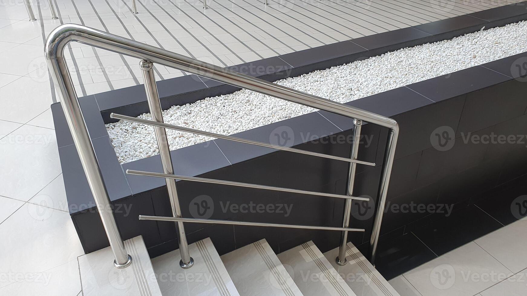 Metallic railing along the staircase. Railing protection from falling down on the staircase. Elderly and disabled people care. photo