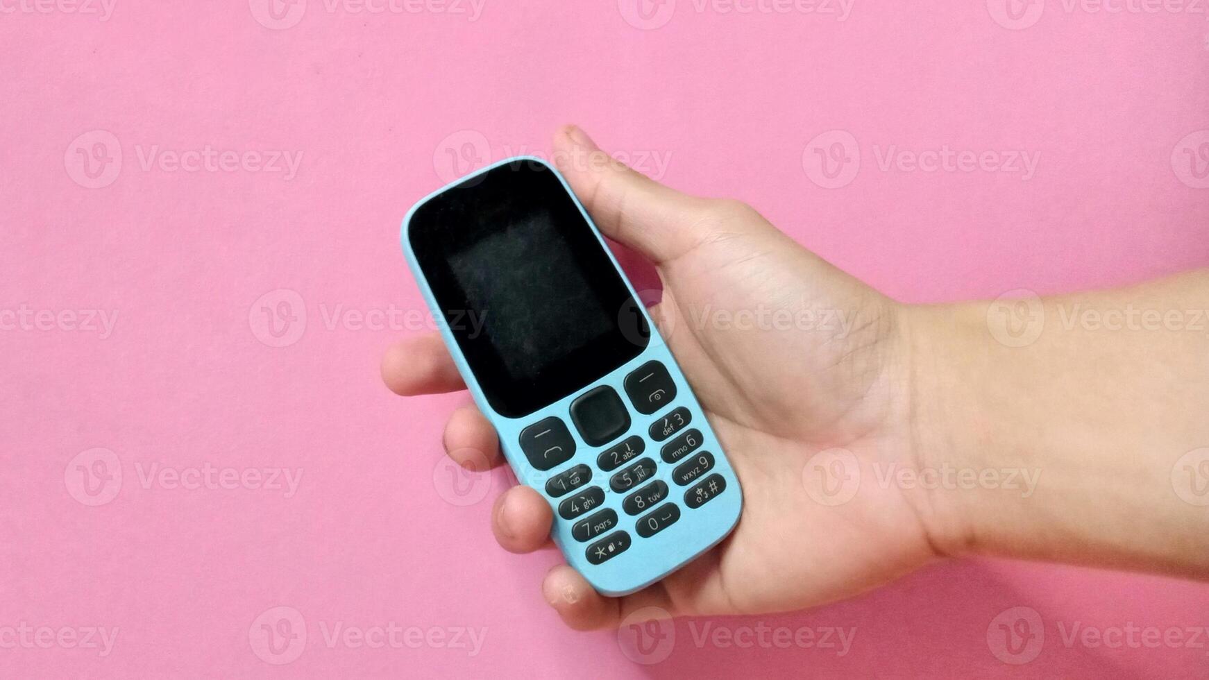 Simple Cell Phone in Hand, Minimalist Communication Technology photo