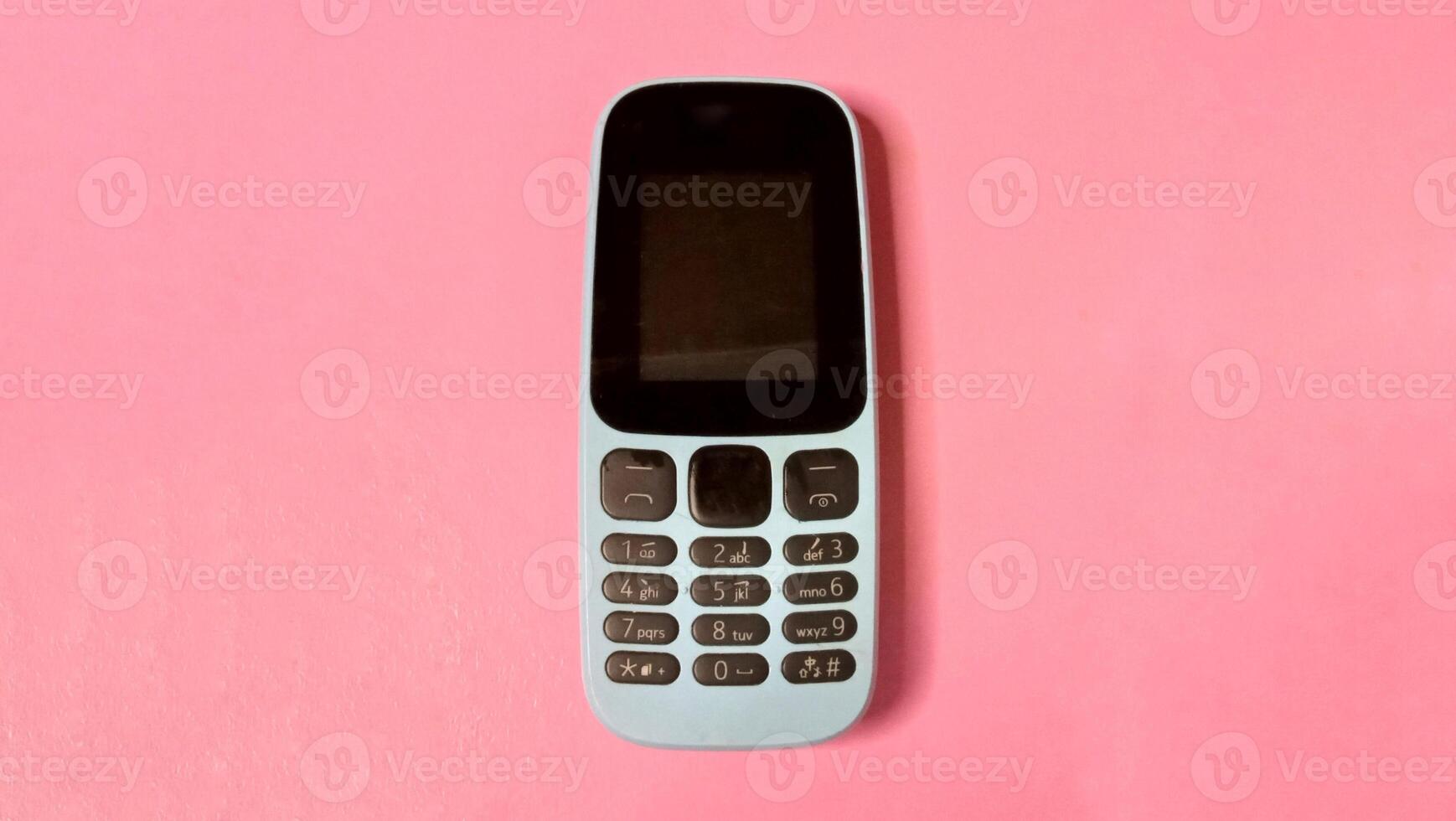 Simple Mobile Phone on Pink Background, Minimalist Technology Concept photo