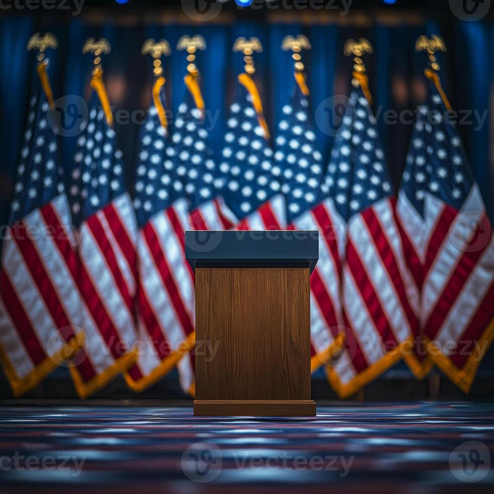 A podium is in front of a row of American flags. The flags are red, white, and blue photo