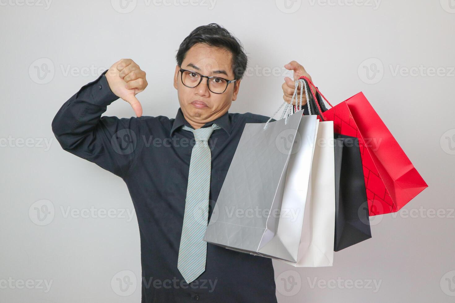 asian man in black shirt giving thumbs down, black friday shopping concept. photo