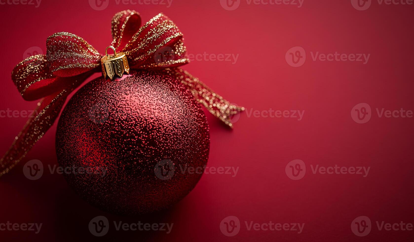 Glittery red holiday ornament. A vibrant red ornament adorned with a shiny ribbon sits on a deep red background, perfect for festive decor. photo
