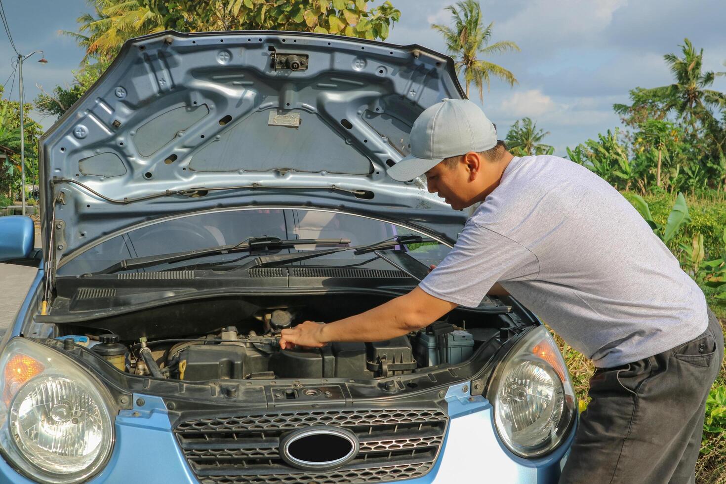 Auto mechanic inspecting the engine room. photo