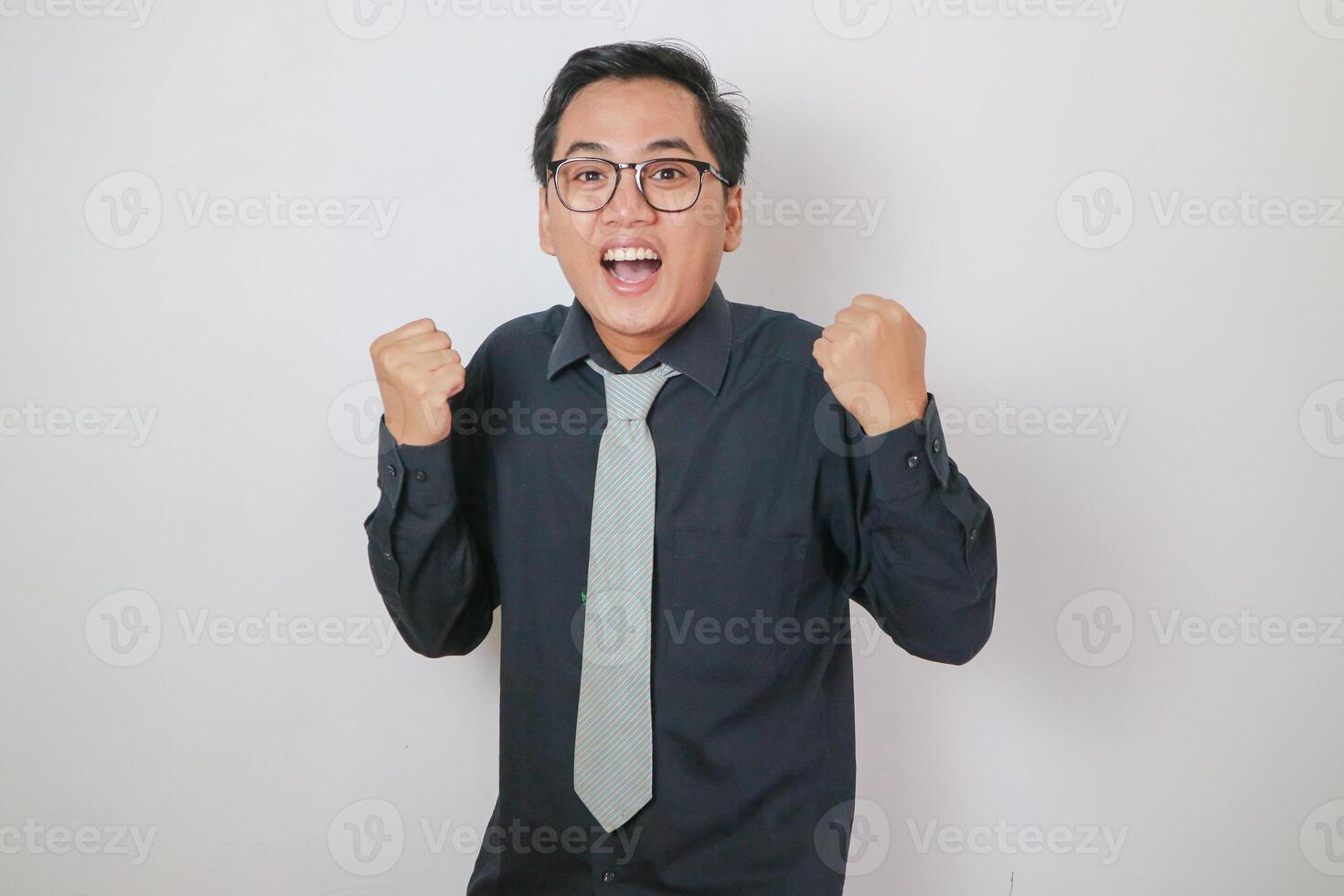 Asian office man wearing black shirt doing success gesture, isolated white office man concept. photo