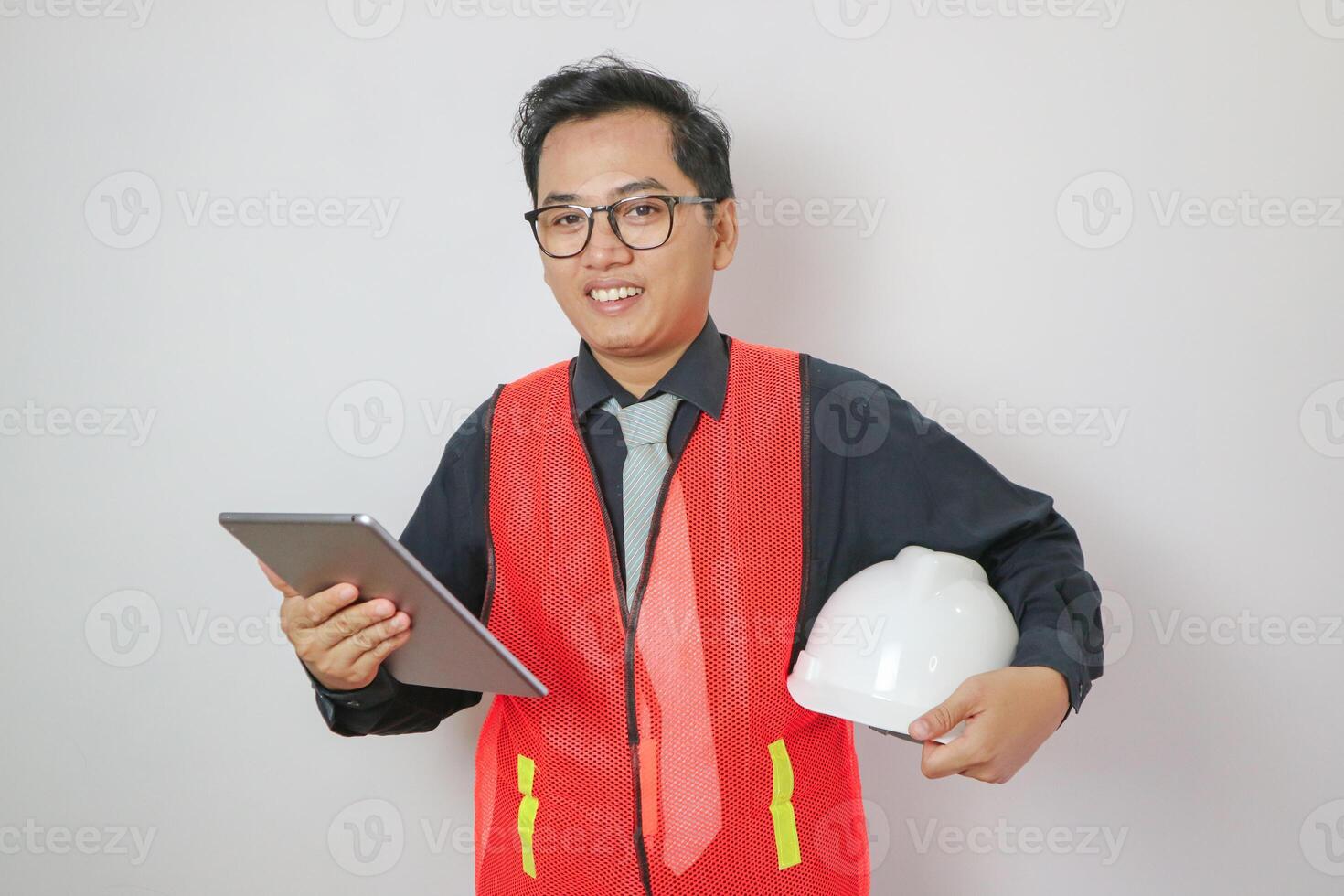 Asian engineer handsome man or architect looking construction with white safety helmet in construction site. Standing at highway concrete road site. photo
