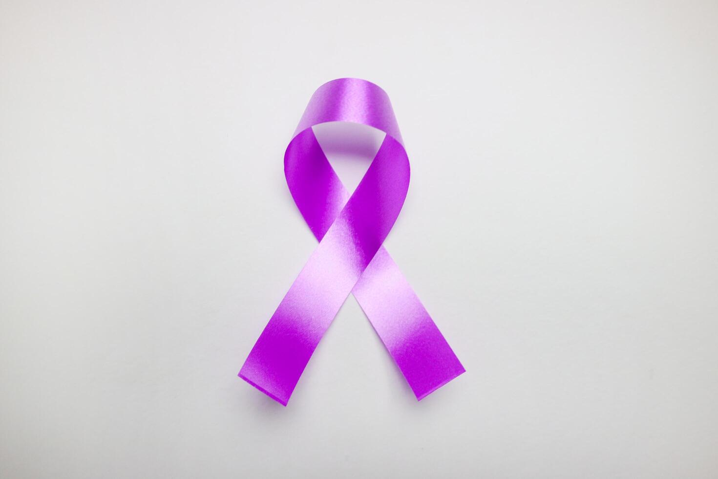 Pink ribbon on white background for supporting World Cancer Day campaign on February. photo