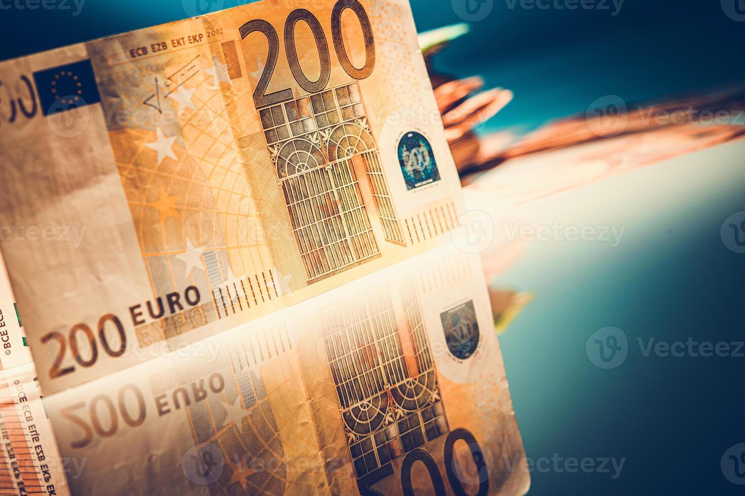 Close-up of a 200 Euro Bill Reflecting on a Smooth Surface in a Dimly Lit Setting photo