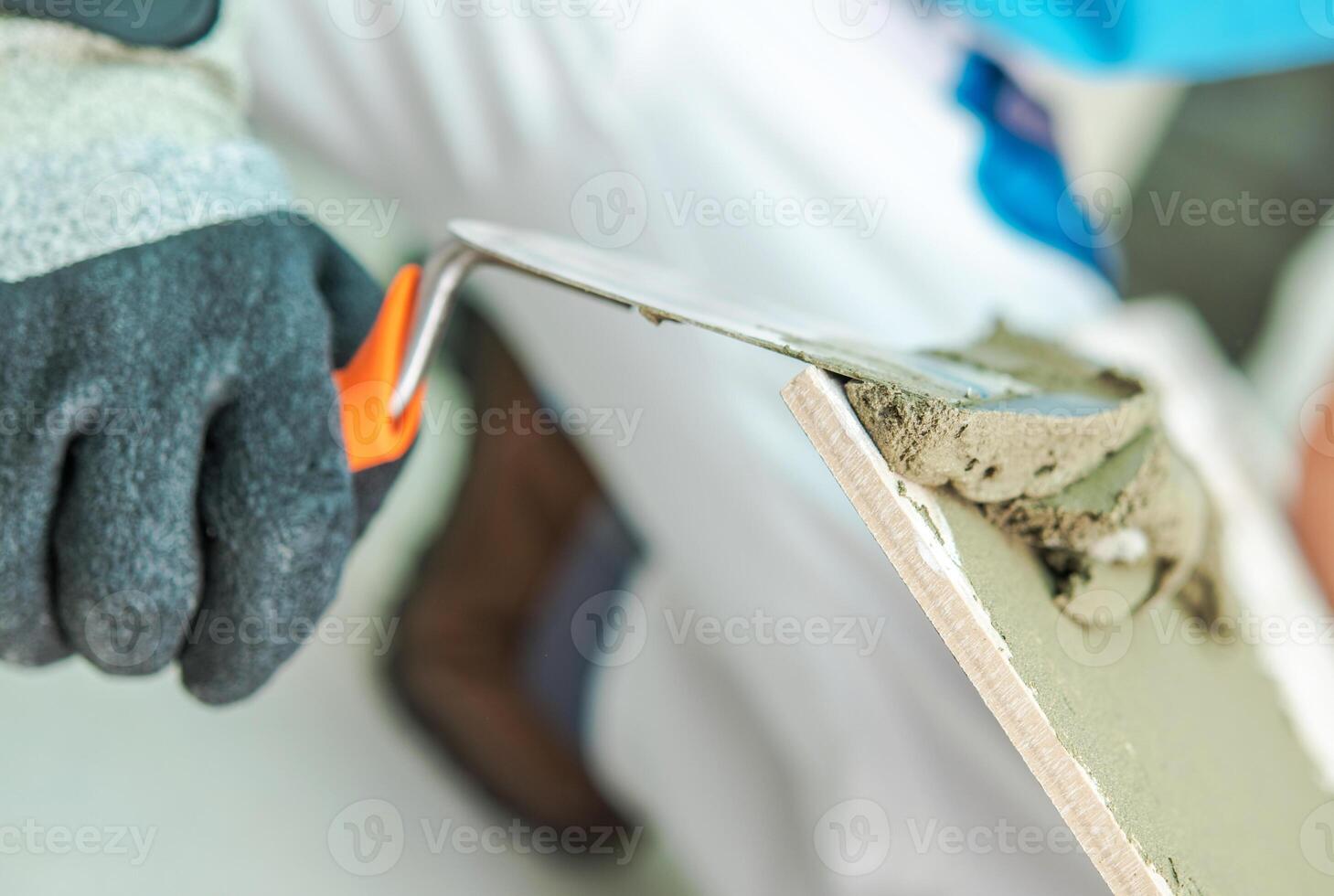 Worker Applying Plaster With a Trowel During Renovation in a Home Interior photo