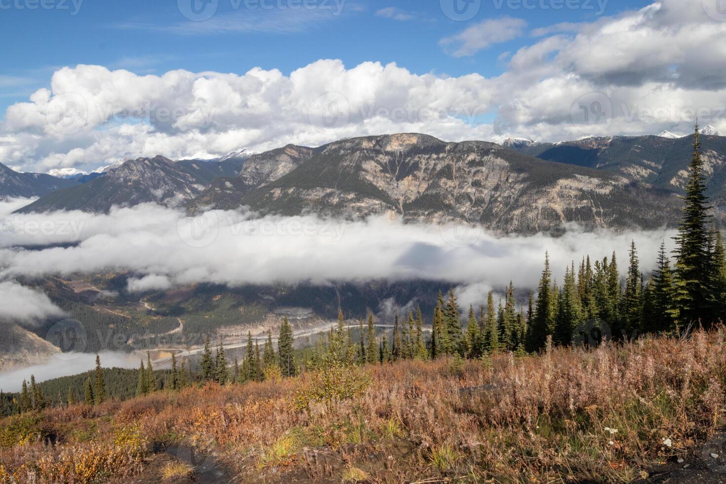 Clouds hanging over a valley in the mountains photo