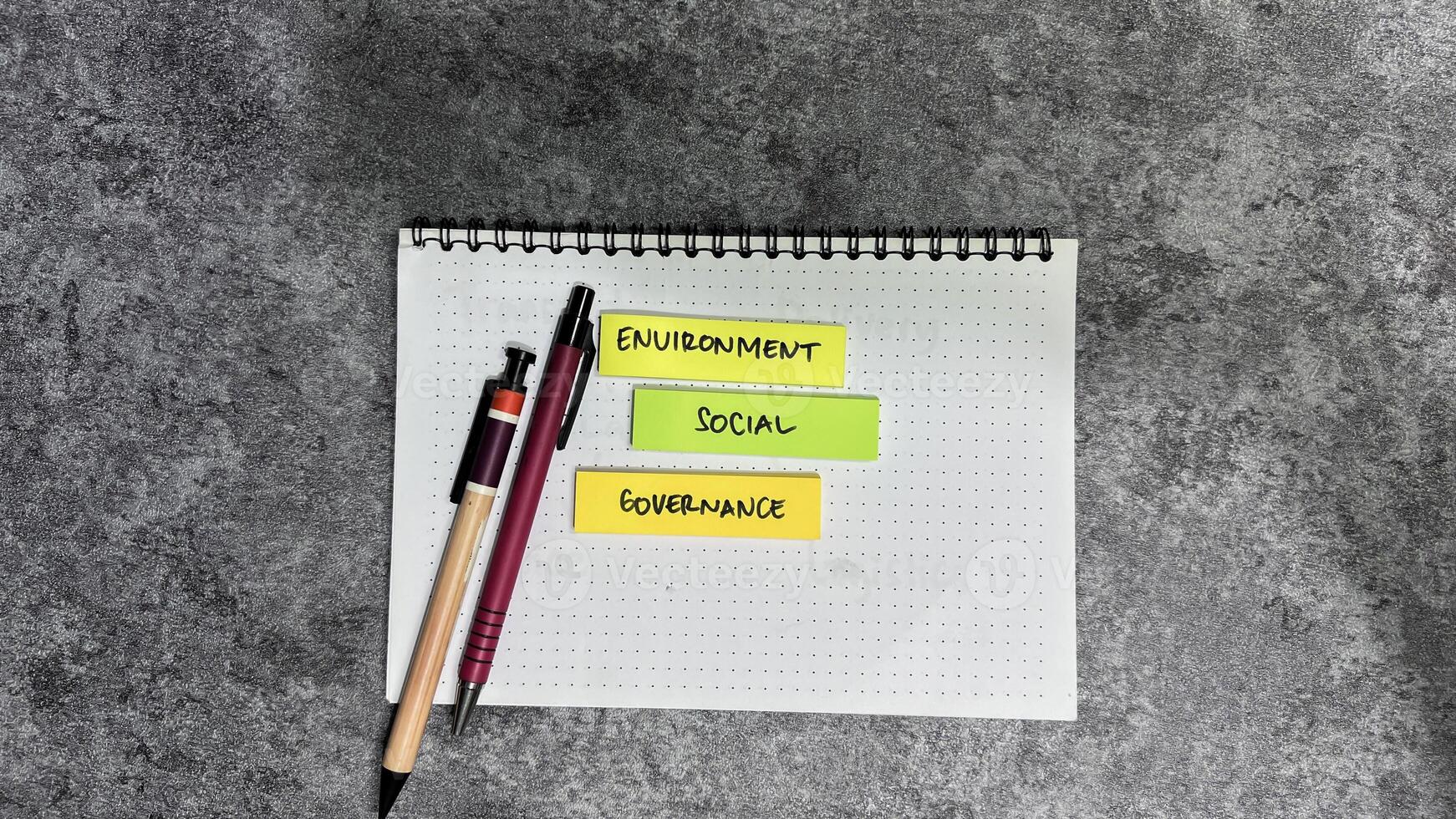 Concept of ESG - Environment Social Governance write on sticky notes isolated on Wooden Table. photo