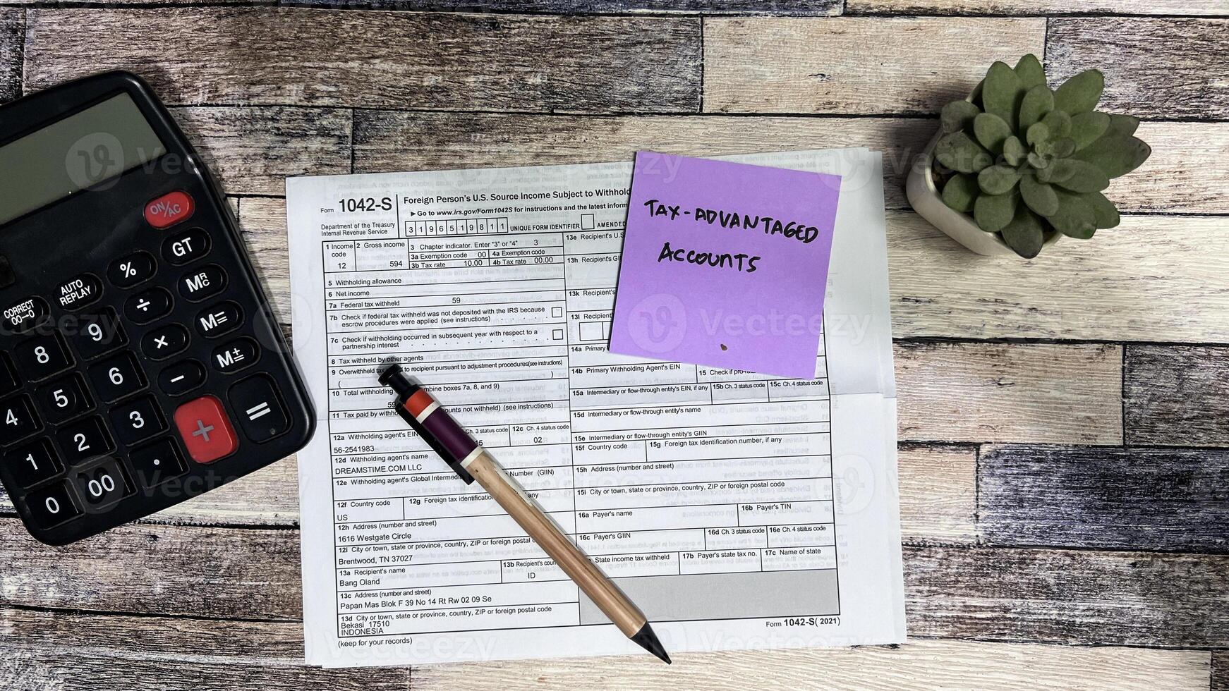 Concept of Tax-Advantaged Accounts write on sticky notes isolated on Wooden Table. photo