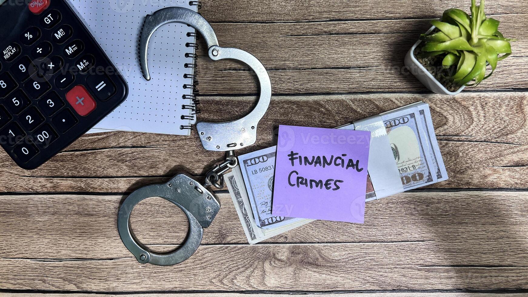Concept of Financial Crimes write on sticky notes isolated on Wooden Table. photo