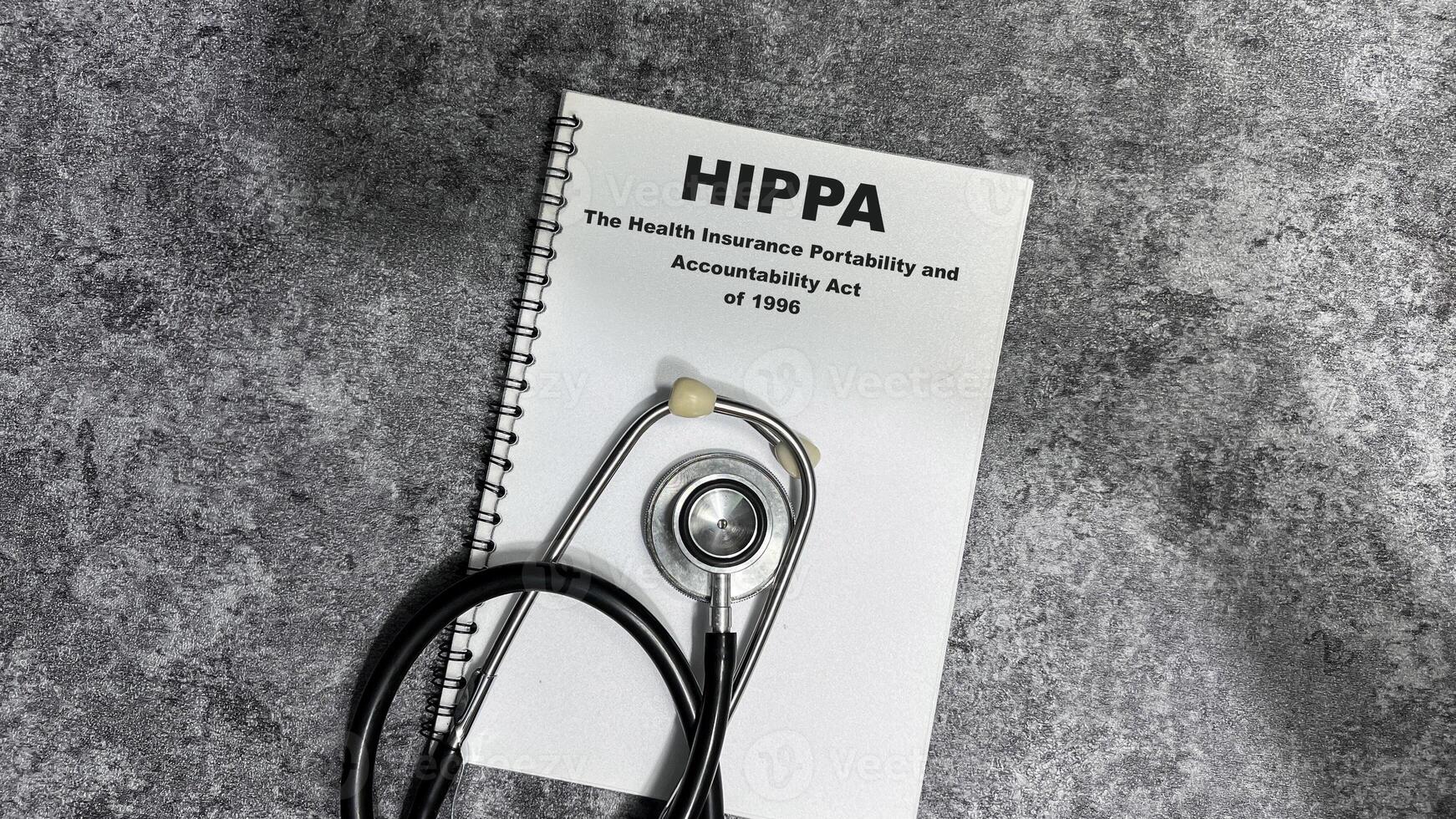 Concept of HIPPA - The Health Insurance Portability and Accountability Act of 1996 write on book isolated on Wooden Table. photo