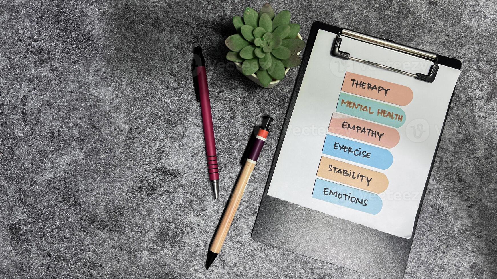 Concept of Mental Health write on sticky notes isolated on Wooden Table. photo
