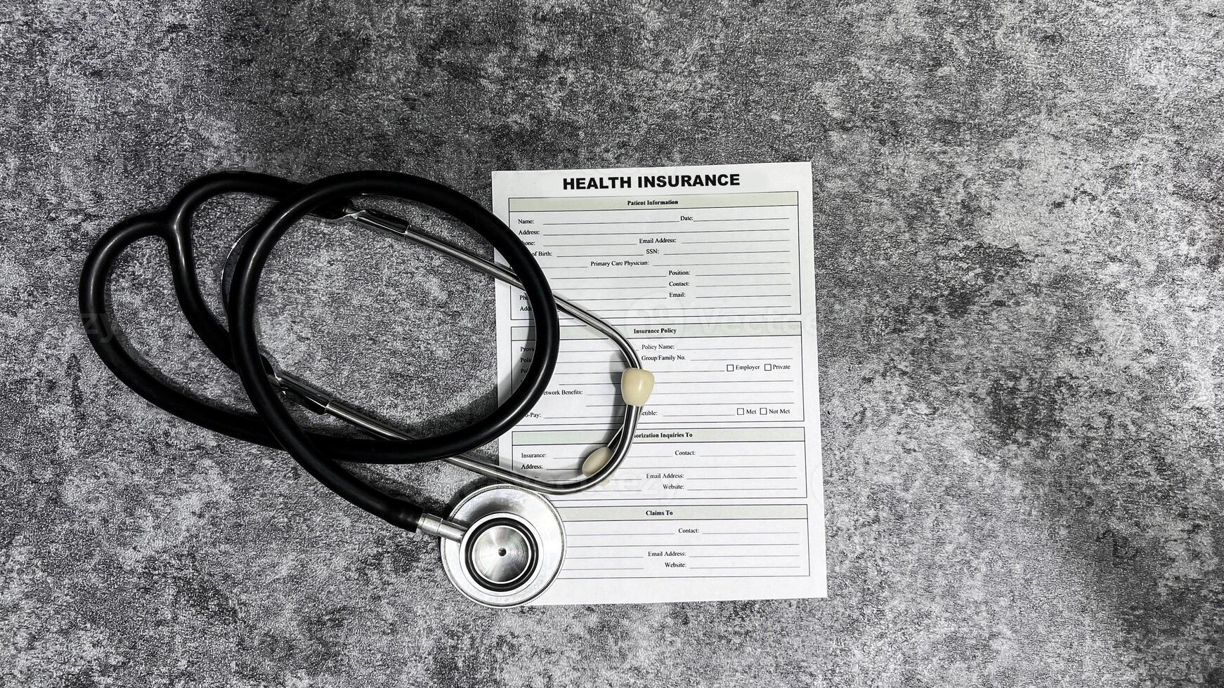 Concept of Health Insurance write on document isolated on Wooden Table. photo