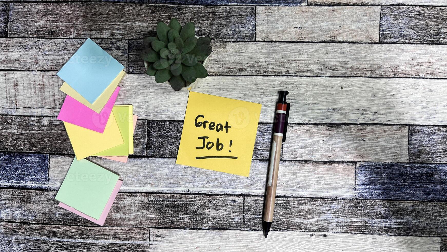 Concept of Great Job write on sticky notes isolated on Wooden Table. photo