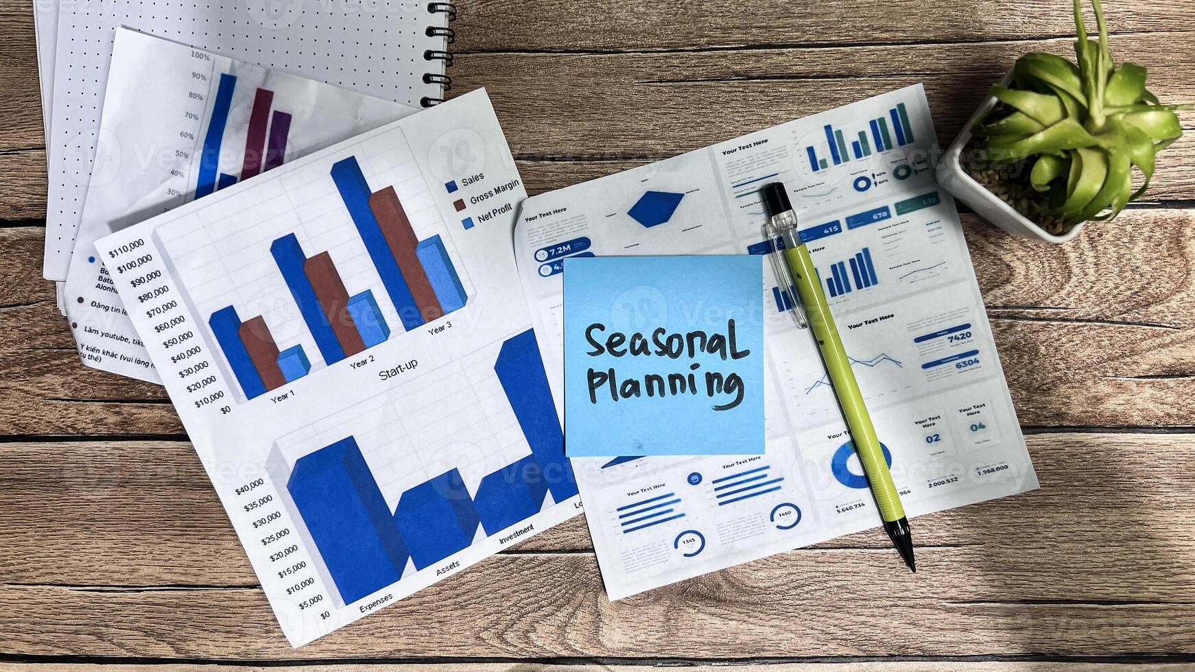 Concept of Seasonal Planning write on sticky notes isolated on Wooden Table. photo