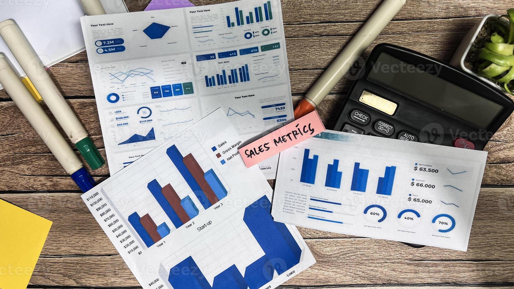 Concept of Sales Metrics write on sticky notes isolated on Wooden Table. photo