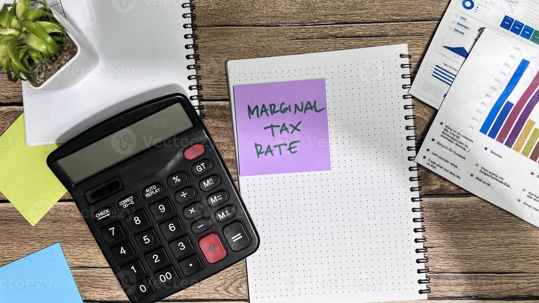 Concept of Marginal Tax Rate write on book isolated on Wooden Table. photo
