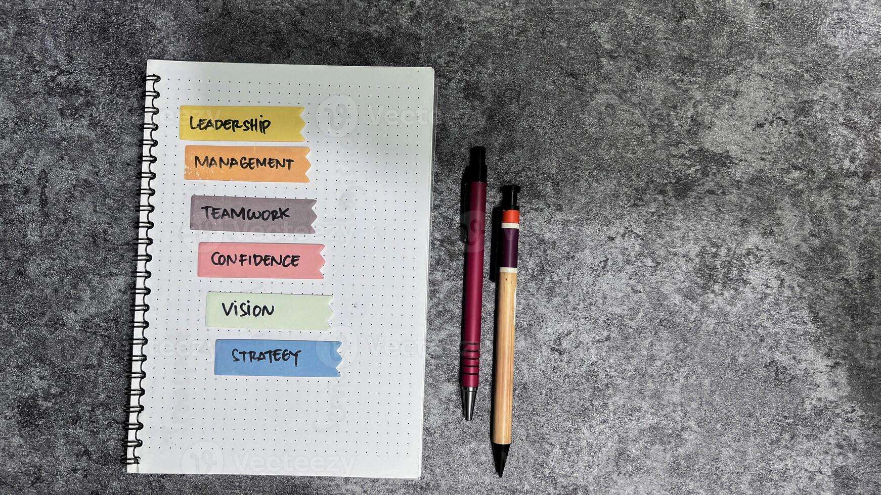 Concept of Leadership, Management, teamwork, Confidence, Vision, Strategy write on sticky notes isolated on Wooden Table. photo