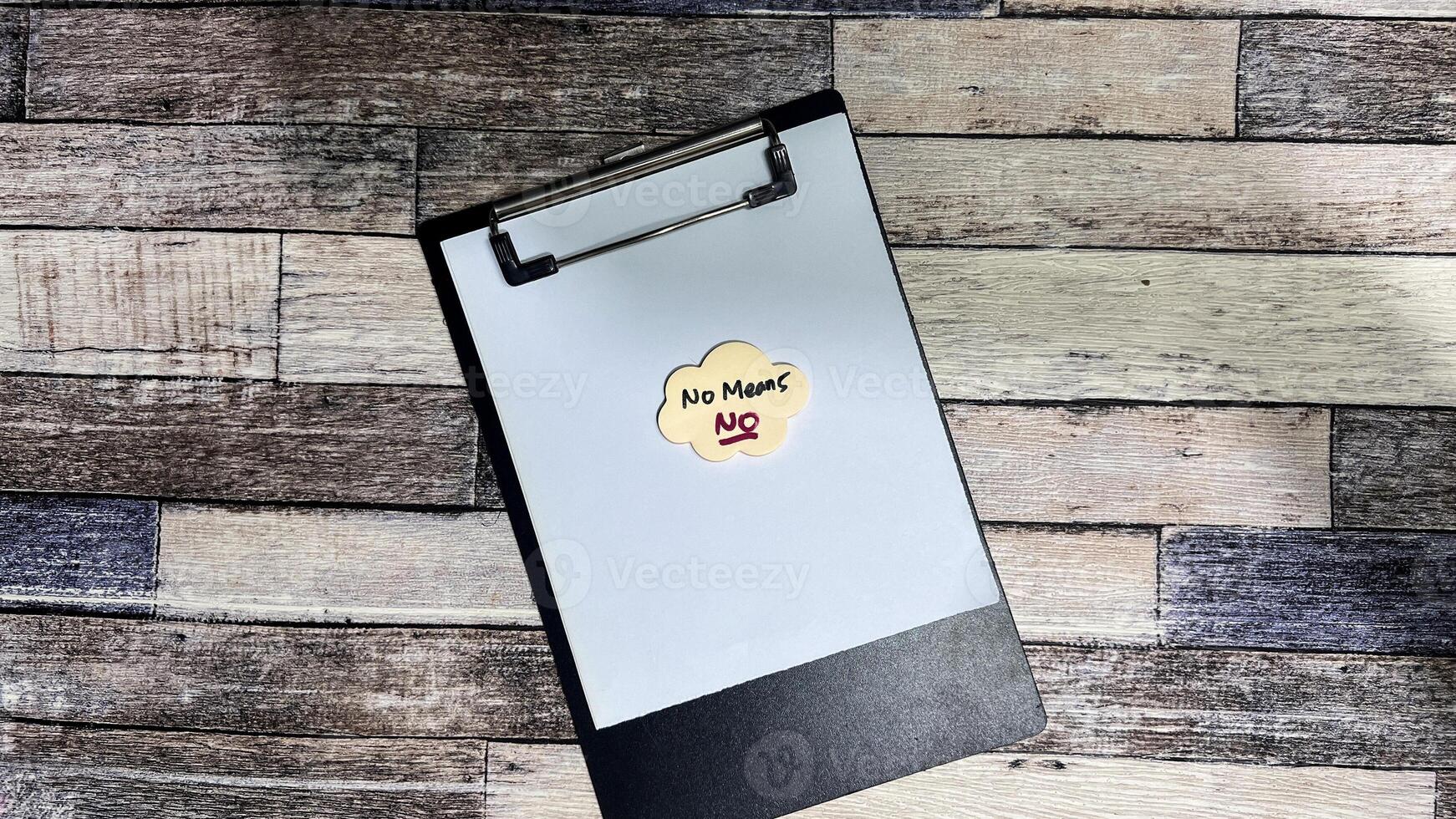 Concept of No Means, No write on sticky notes isolated on Wooden Table. photo