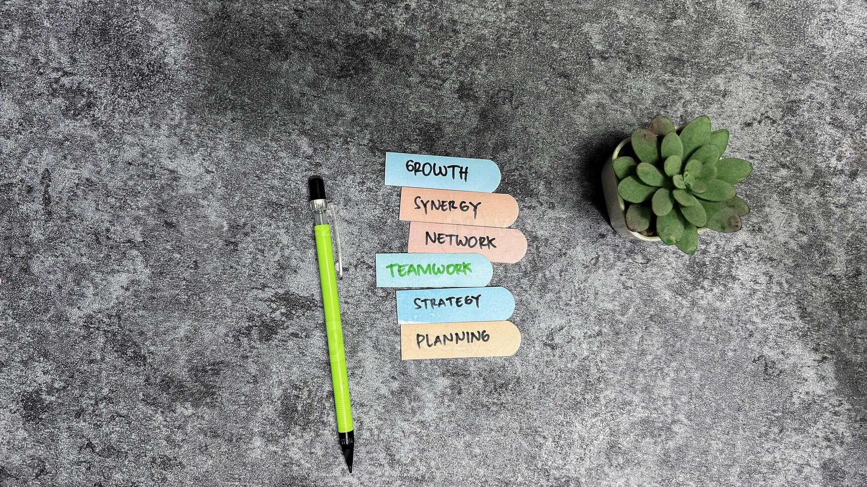 Concept of Teamwork Related write on sticky notes isolated on Wooden Table. photo