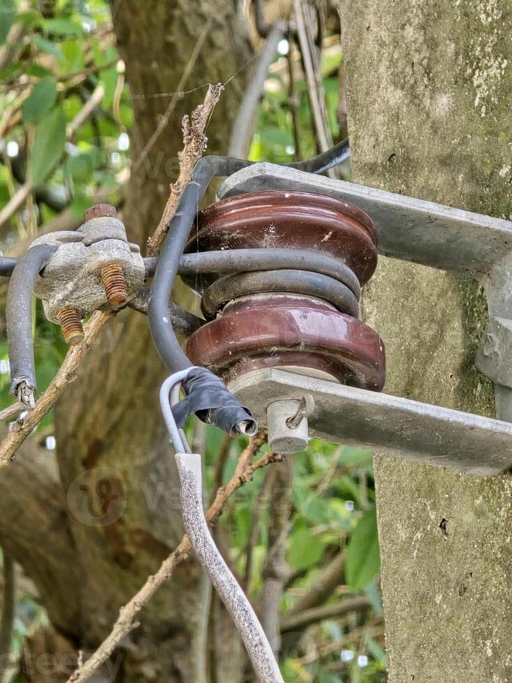 Closeup of insulators on a high voltage electric pillar photo