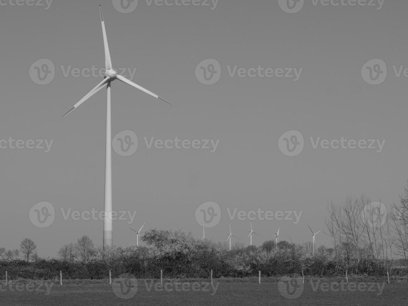 A black and white photo of a wind turbine