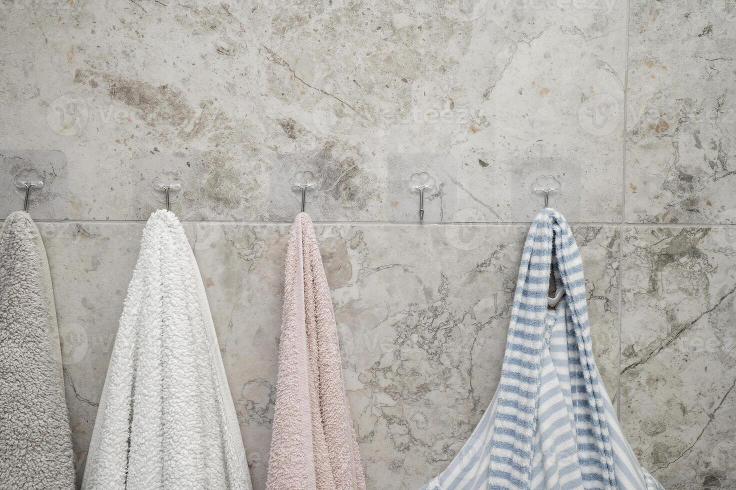 Towels hanging on the wall in the bathroom photo