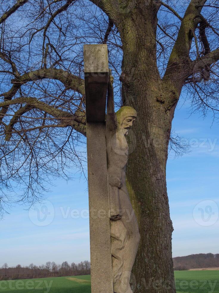 A statue of a man hanging from a tree photo