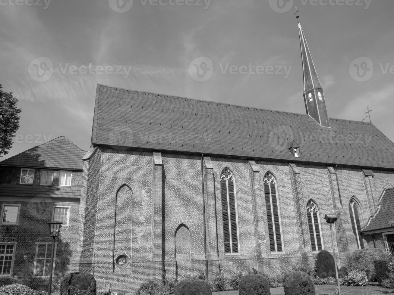 Black and white photo of a church with a steeple in burlo