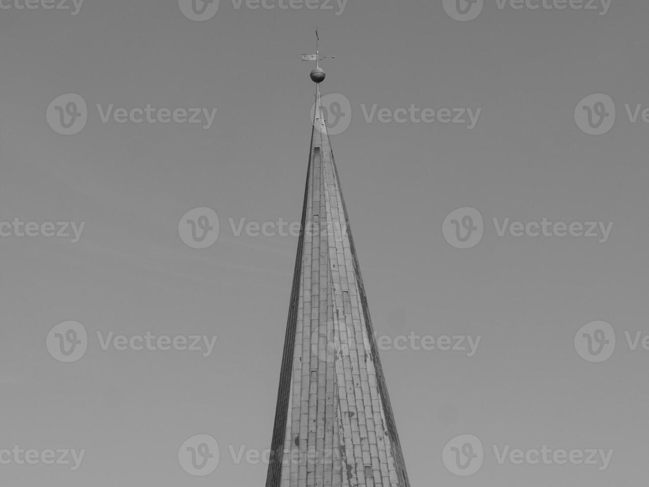 A black and white photo of a steeple