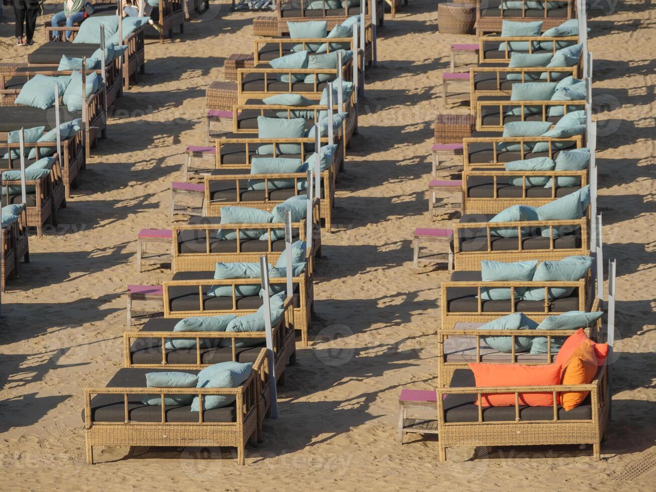 A row of chairs on a beach photo