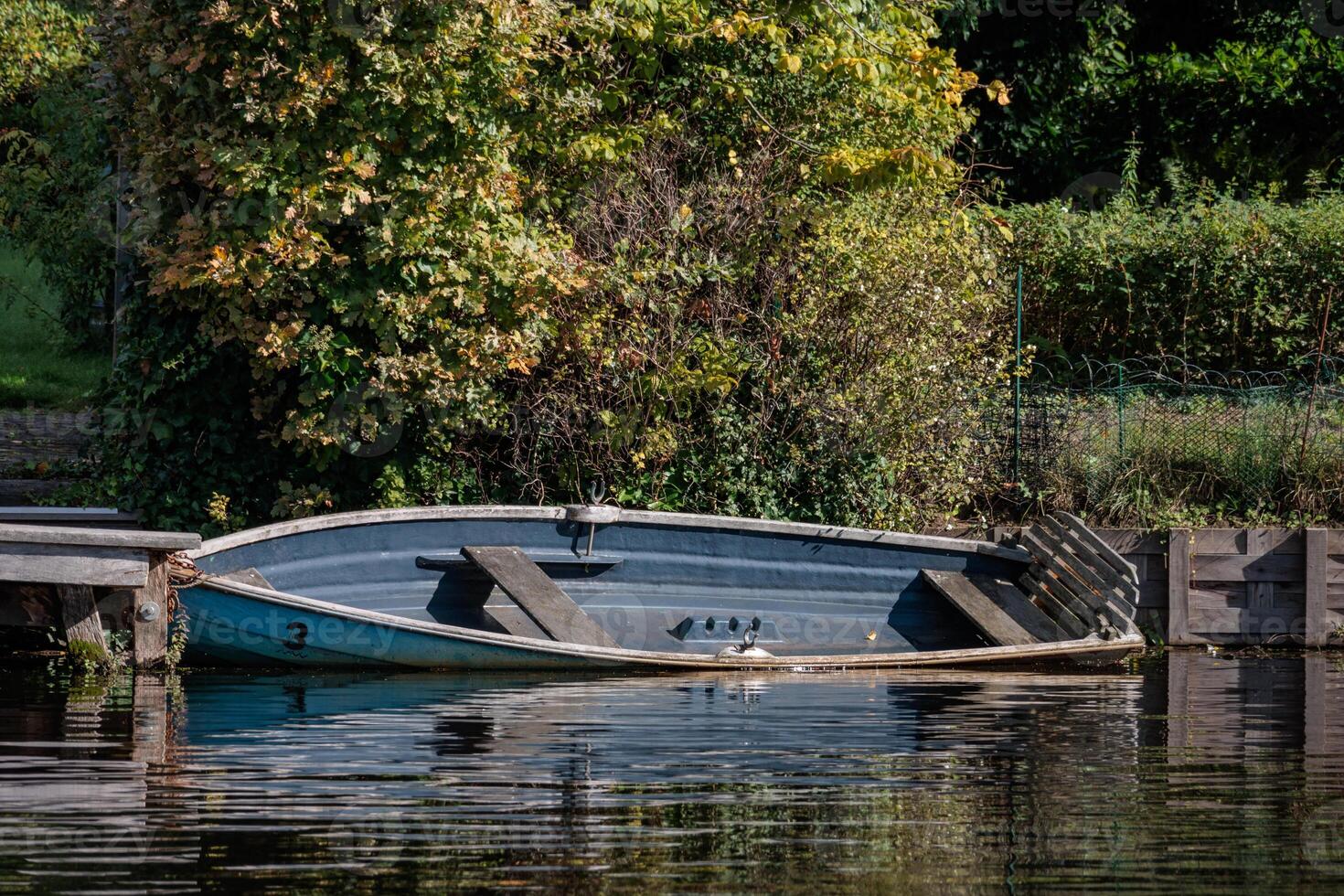 A boat is docked on the water in hamburg photo